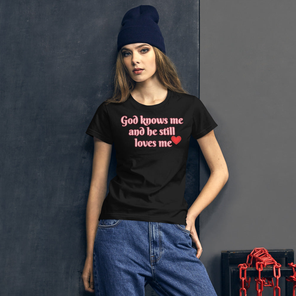 Women's Black T-shirt with God knows me and he still loves me in light Pink letters outlined in Burgundy with a red heart