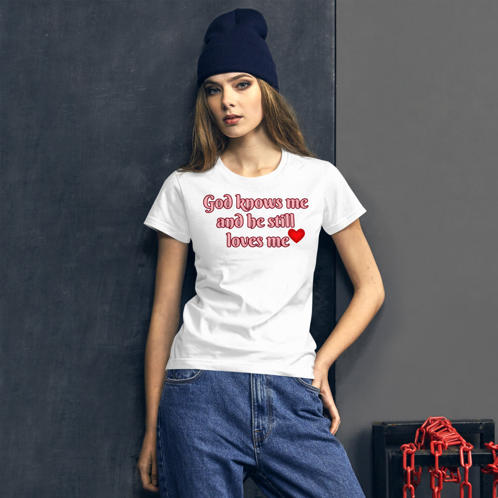 Women's White t-shirt with God knows me and he still loves me in light pink letters outlined in burgundy with a red heart