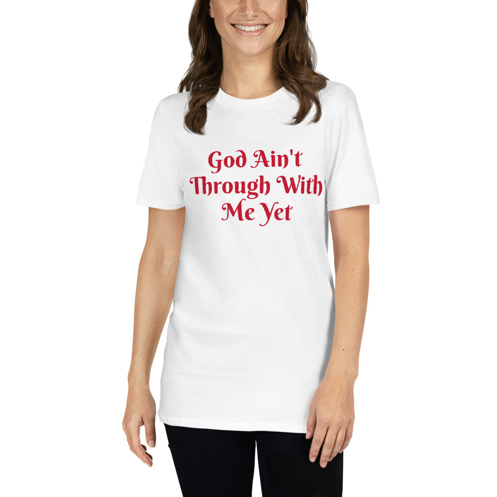 Unisex soft-style White t-shirt with GOD AIN'T THROUGH WITH ME YET in Red letters