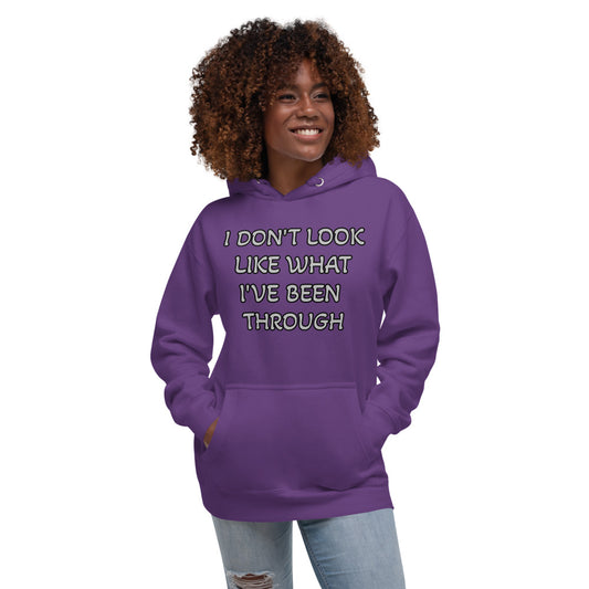 Purple Unisex Hoodie with I don't look like what I've been through in White letter outlined in Black