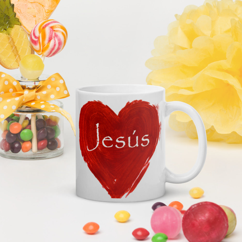White 11.0z mug with a red heart and Jesus' name written in white on the outside of the muge heart